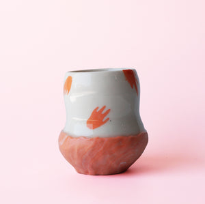 Floating hand orange cup
